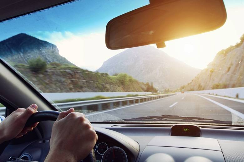 hands of driver on the steering wheel